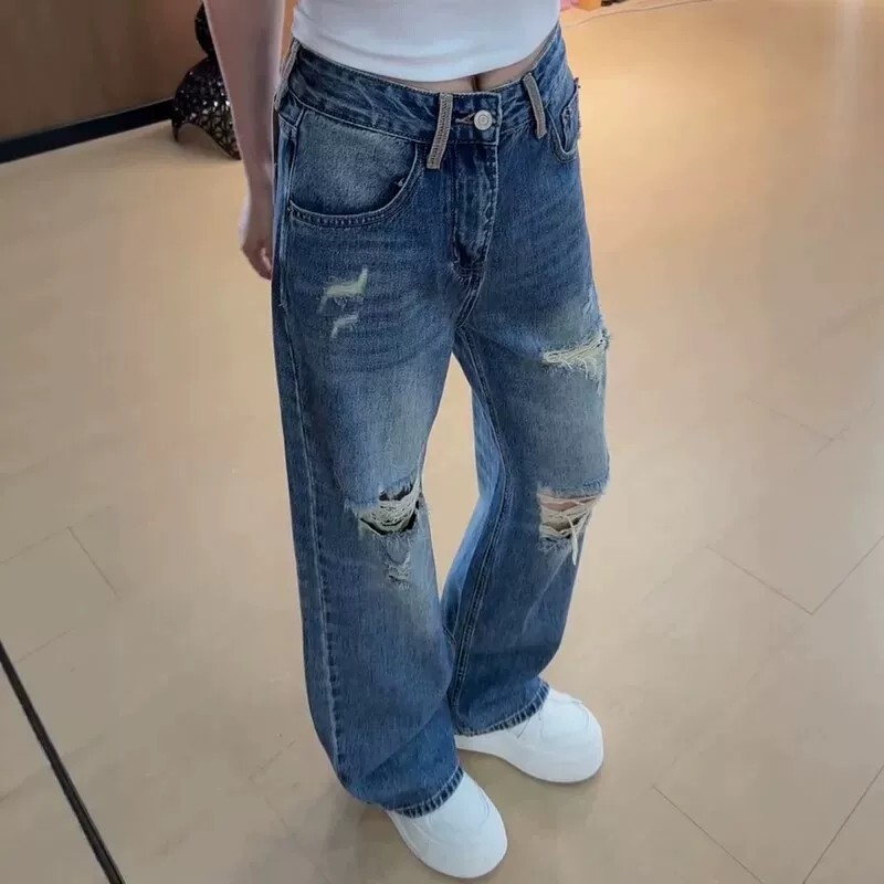 Stylish distressed jeans with a curved cut—a trendy new spring arrival featuring a high-waisted, wide-leg, floor-length silhouette.