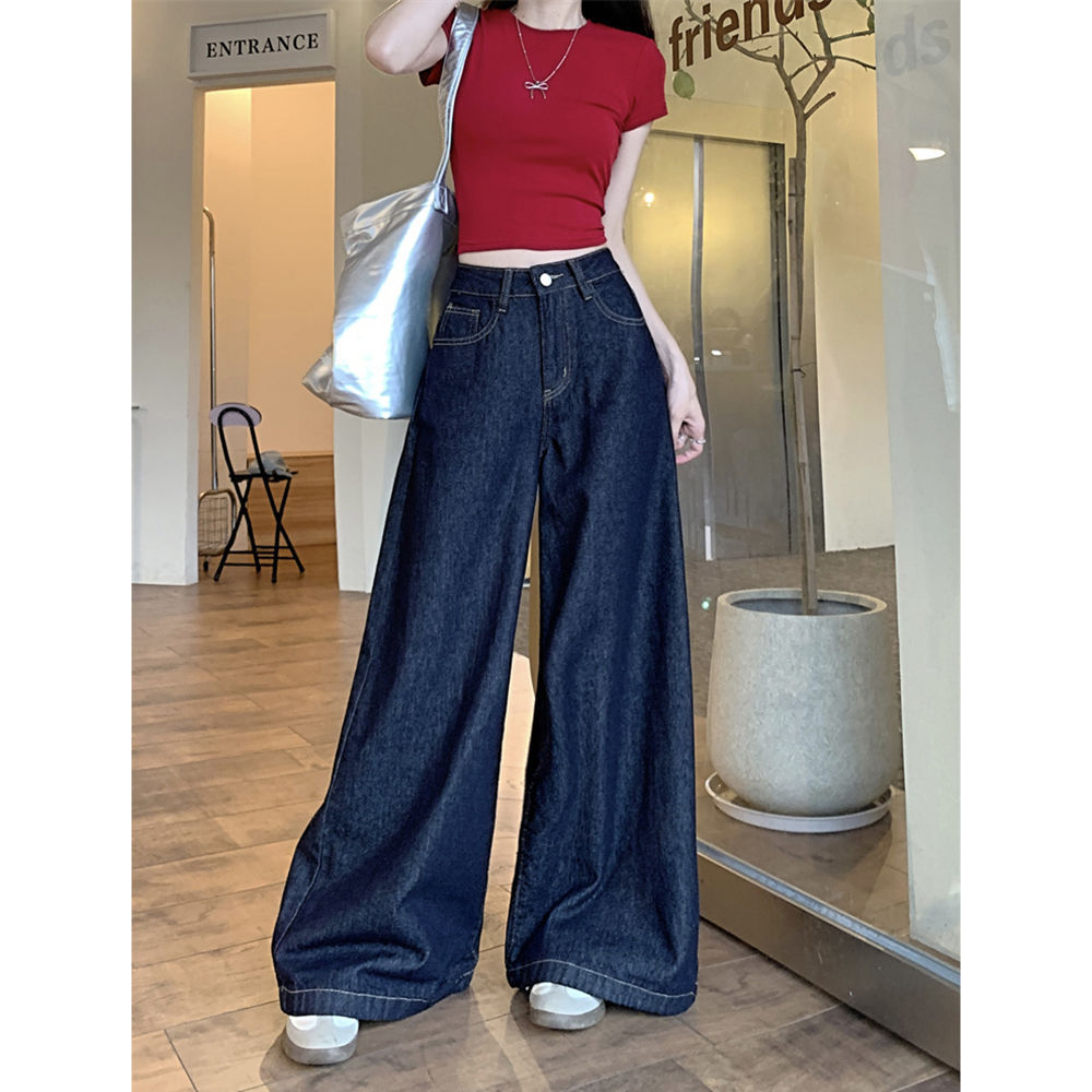 Springtime wide-leg denim jeans, dark blue, slimming and flattering, perfect for wearing outside.