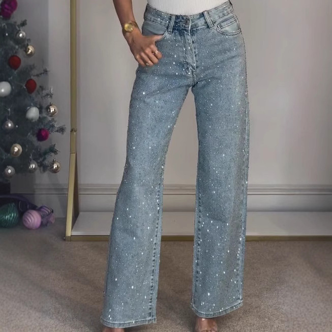 Women's high-waisted, straight-leg, acid-wash jeans featuring an all-over rhinestone design—a sexy style.