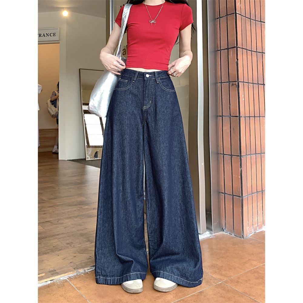 Springtime wide-leg denim jeans, dark blue, slimming and flattering, perfect for wearing outside.